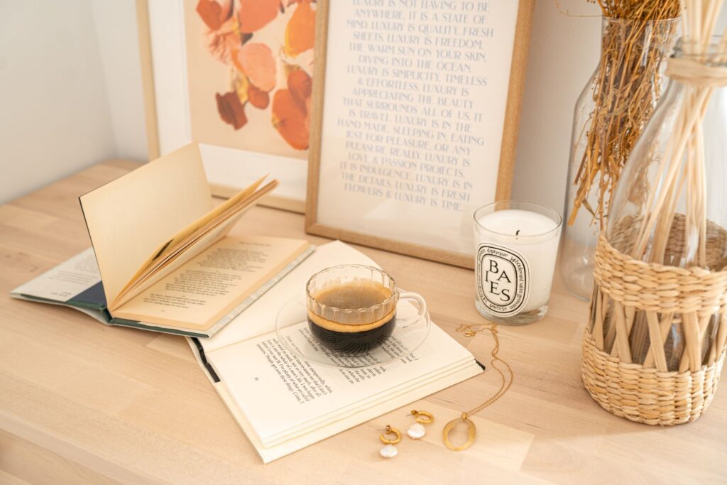 a picture of a table with flowers, coffee, and books