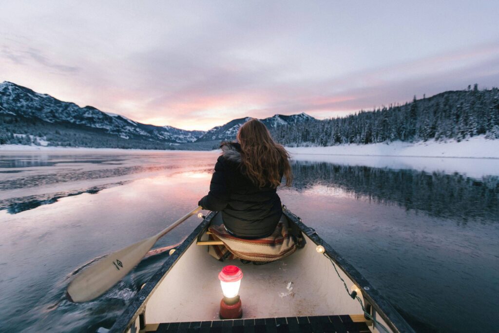 a girl kayaking in a lake