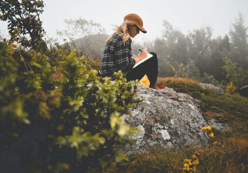 a girl journaling outdoors