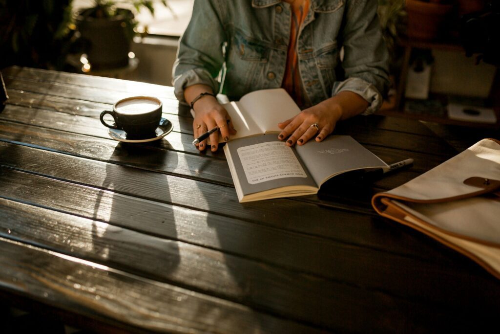 a girl journaling while having coffee