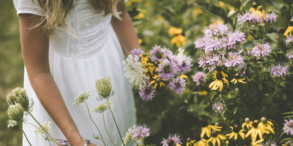 a girl living a simple life, playing with flowers in the garden