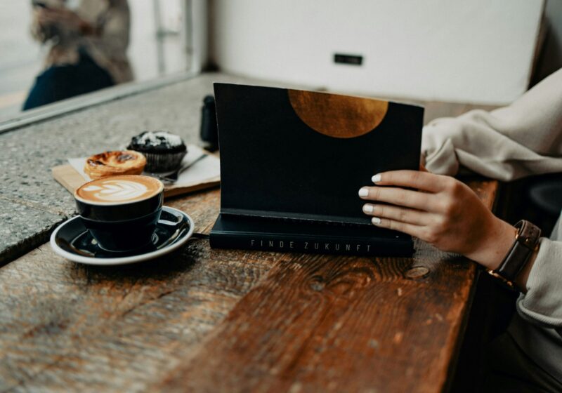 a women journaling while having coffee and cupcakes