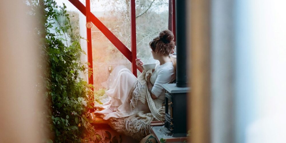 woman in white dress sitting on brown wooden chair practicing mindfulness affirmations