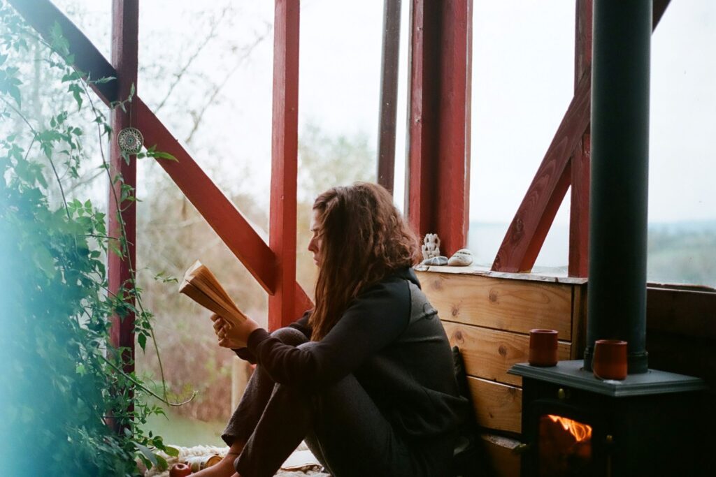 woman sitting on brown wooden bench practicing mindfulness affirmations