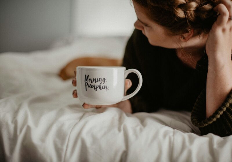 a girl journaling while having morning coffee