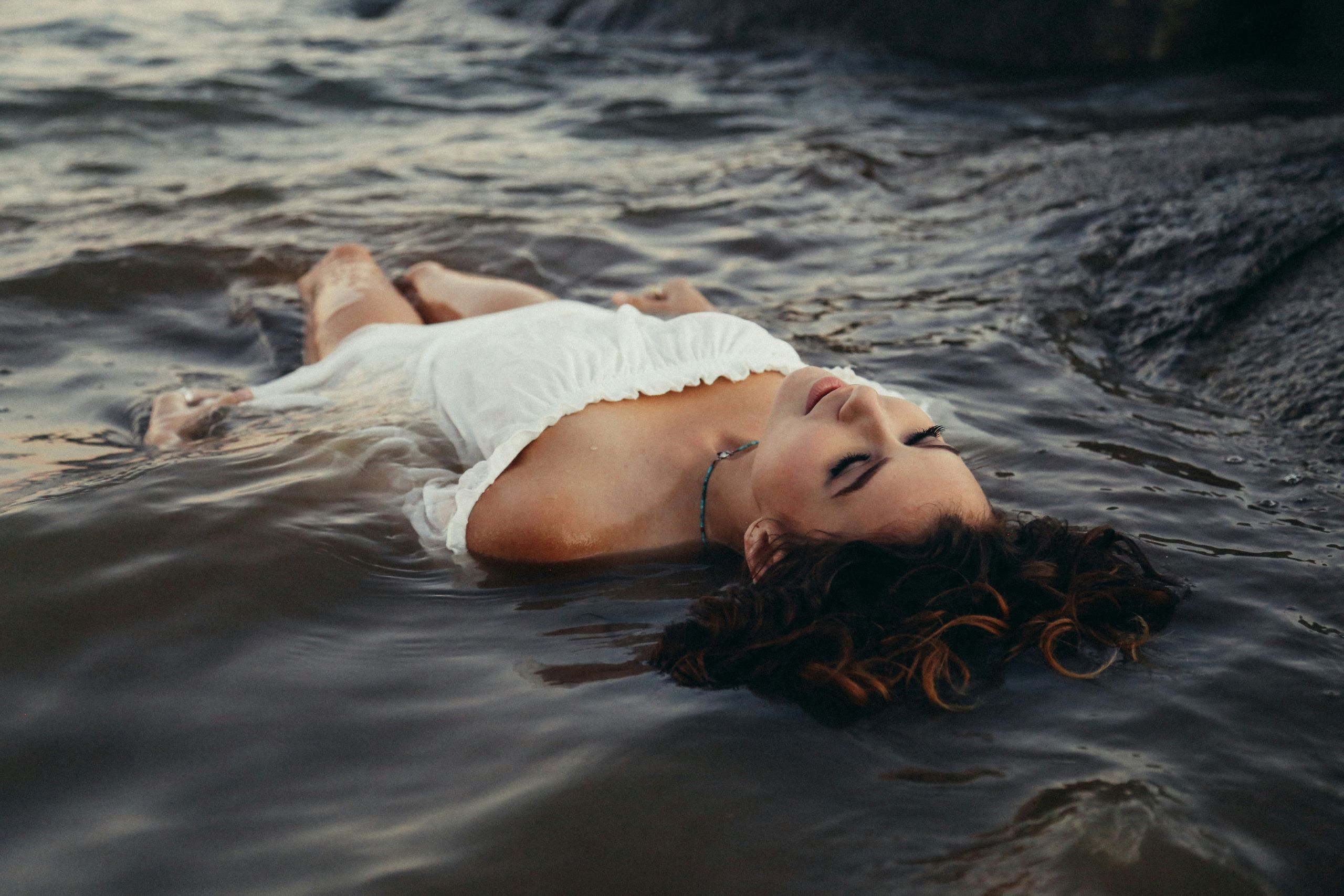 woman relaxing on body of water practicing mindfulness