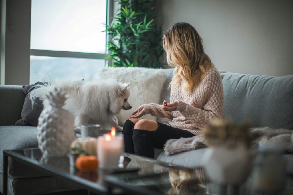 woman sitting on sofa practicing self-care