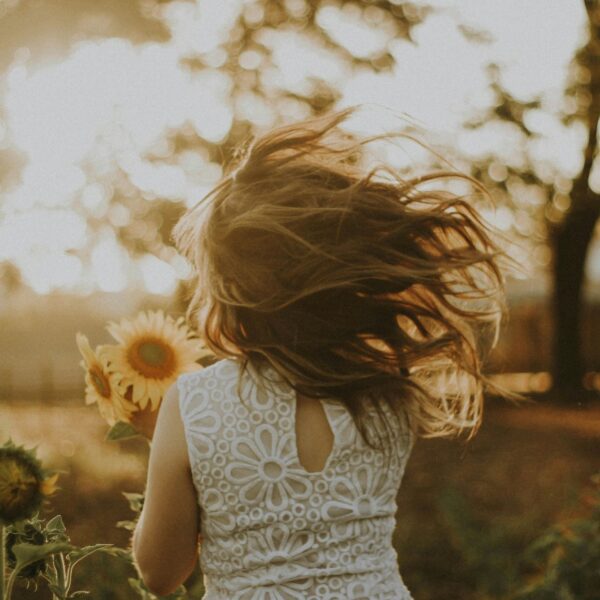 woman holding sunflower living a slow and simple life