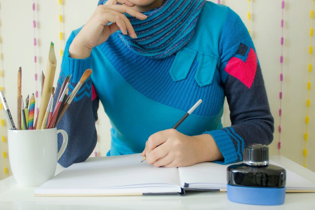 a woman writing her journal as a hobby