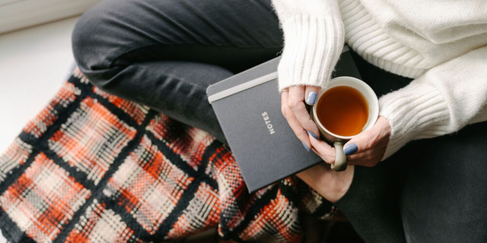 a girl sitting with her journal and morning tea