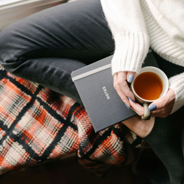 a girl sitting with her journal and morning tea