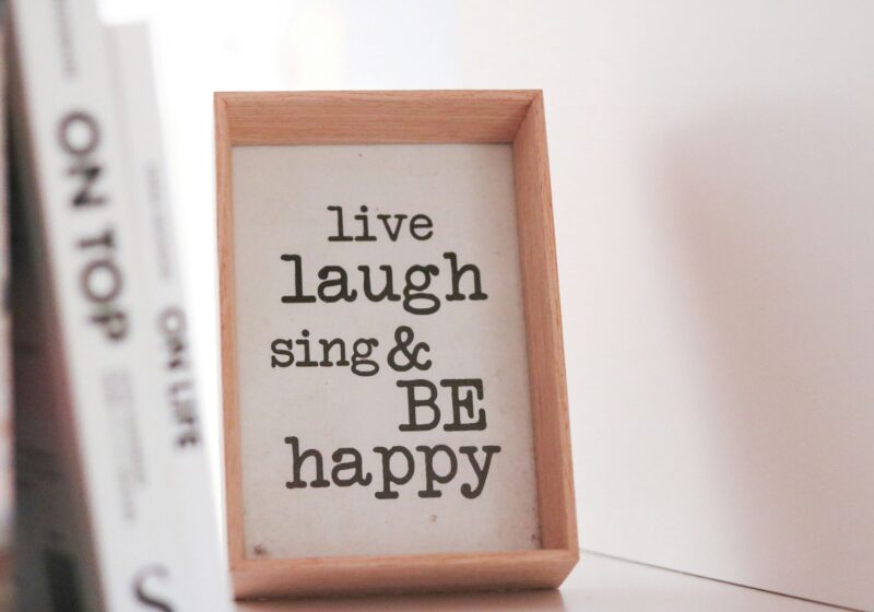 This image captures a simple and cheerful morning vibe with a framed quote that says, "Live, laugh, sing, and be happy," reminding you to embrace joy every day.