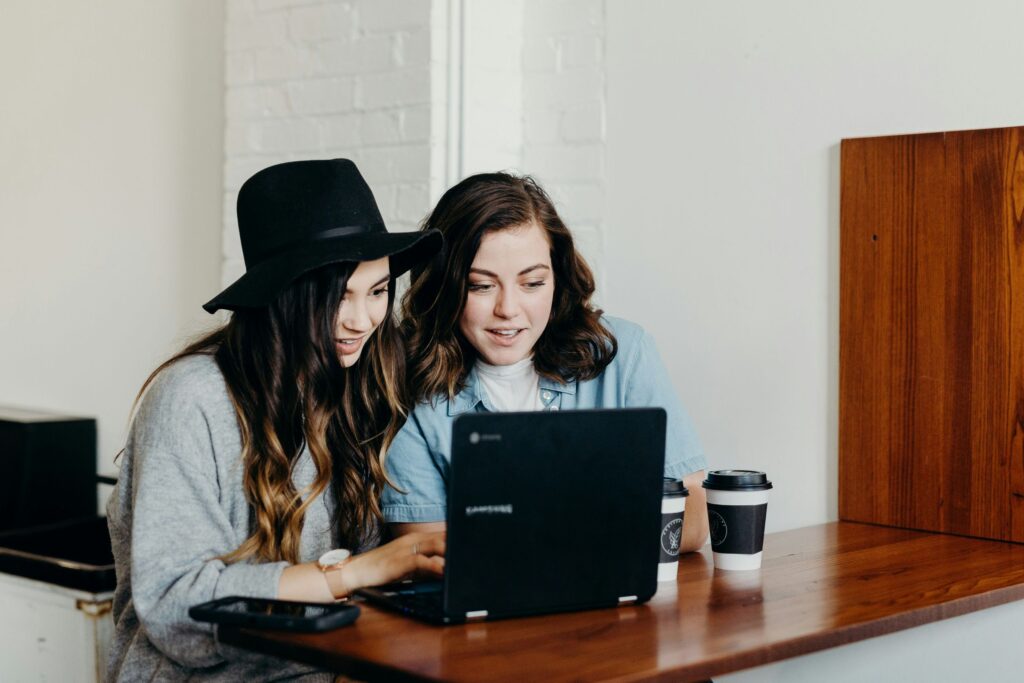 Practicing mindfulness at work also means mindful communication. This image shows two women collaborating with focus and intention.