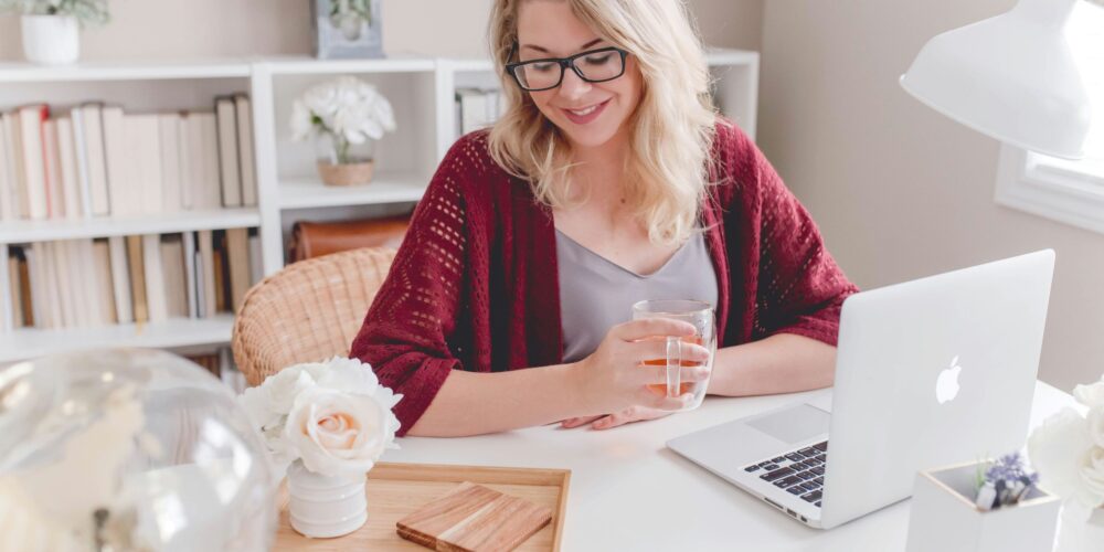 This image represents mindfulness in the workplace, showing a woman working calmly and staying focused on her computer.