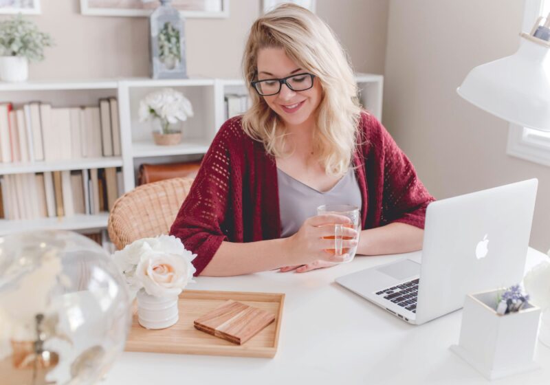 This image represents mindfulness in the workplace, showing a woman working calmly and staying focused on her computer.