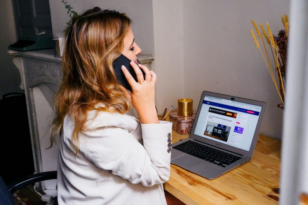 A woman working remotely on her laptop, reflecting the need to manage work stress and create balance in flexible work environments.