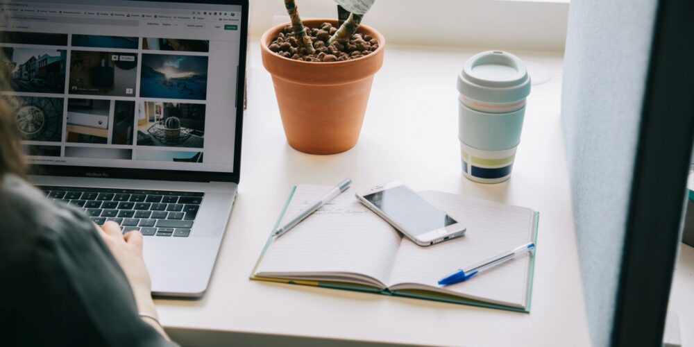 A focused woman working remotely on her laptop, symbolizing the dedication and drive behind many professionals. The image connects to the theme of perfectionism and work life balance, showing the need to manage ambition without sacrificing mental health.