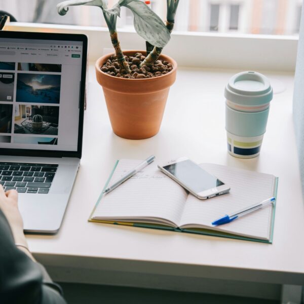 A focused woman working remotely on her laptop, symbolizing the dedication and drive behind many professionals. The image connects to the theme of perfectionism and work life balance, showing the need to manage ambition without sacrificing mental health.