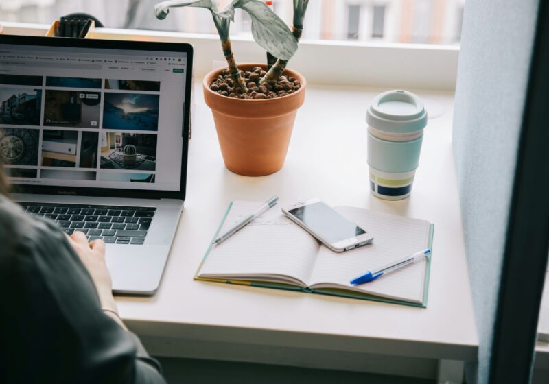 A focused woman working remotely on her laptop, symbolizing the dedication and drive behind many professionals. The image connects to the theme of perfectionism and work life balance, showing the need to manage ambition without sacrificing mental health.