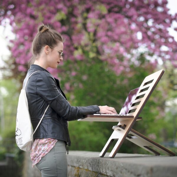 Woman working remotely from home with a laptop, representing mindful work habits and healthy work-life balance tips for remote workers.