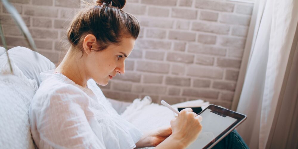 a lady doing digital journaling on her iPad