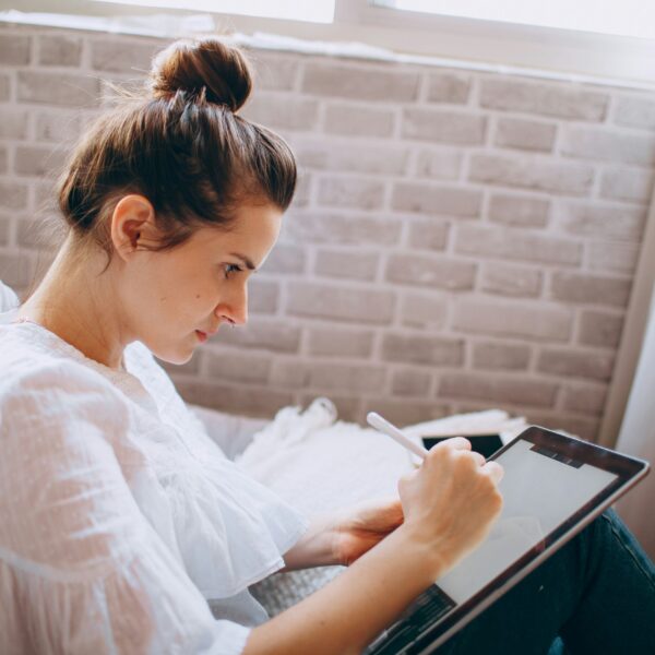a lady doing digital journaling on her iPad