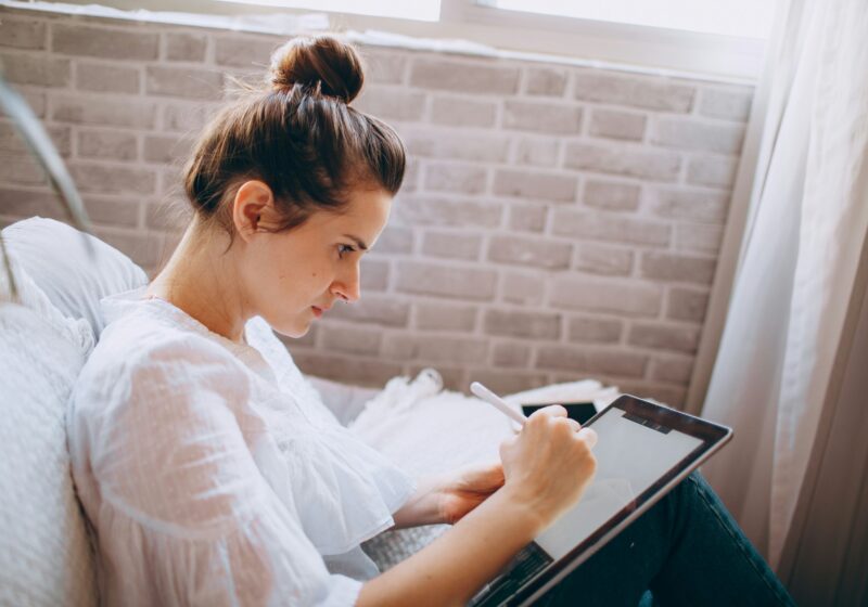 a lady doing digital journaling on her iPad