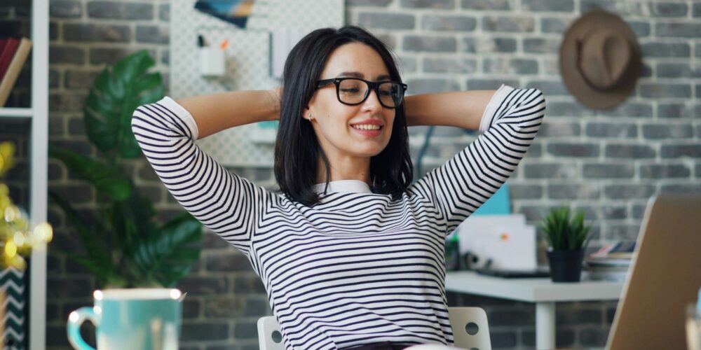 A girl happily working at office