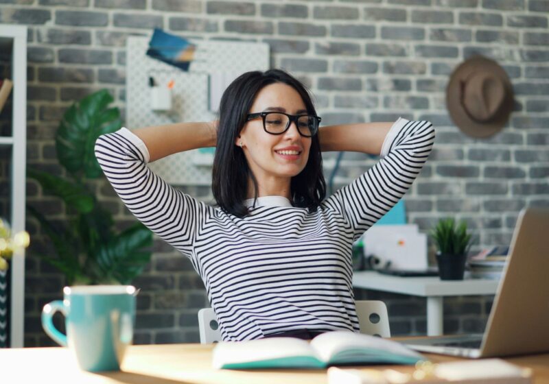 A girl happily working at office